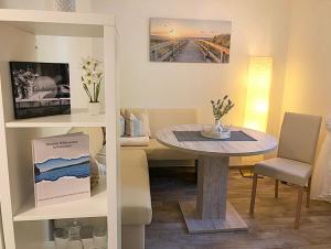 a living room with a table and a couch at Naturblick am Petersdorfer See in Petersdorf +11 photos