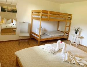 two swans are sitting on a bed in a bedroom at Naturblick am Petersdorfer See in Petersdorf