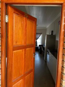 a door leading to a kitchen and a living room at Impact in Bloemfontein
