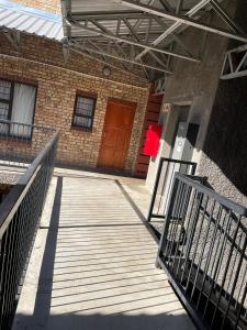 a staircase leading to a building with a red door at Impact in Bloemfontein