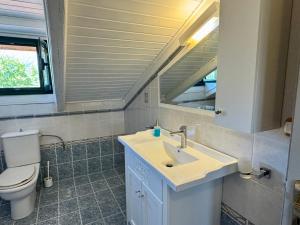 a bathroom with a sink and a toilet at WhiteHome Vasiliki in Vasiliki +15 photos