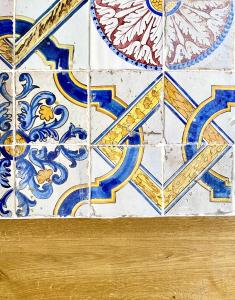 a tile floor with blue and gold mosaics on it at Palazzo 700 in Castellammare del Golfo