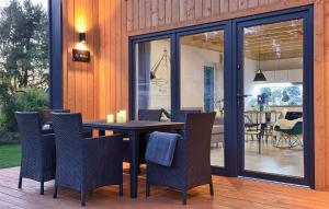 a dining room with a table and chairs at Amazing Home In Bialogora With Wifi in Białogóra +19 photos