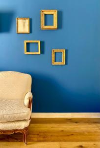 a blue wall with a chair in a room at Palazzo 700 in Castellammare del Golfo +44 photos