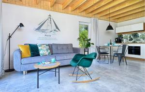 a living room with a couch and a table at Nice Home In Bialogora With Wifi in Białogóra