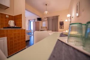 a kitchen and living room with a counter top at Stella Studios in Poros +42 photos