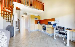 a kitchen with yellow cabinets and a staircase in a room at Pet Friendly Apartment In Hyères in Hyères