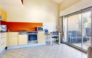 a kitchen with a stove and a microwave at Pet Friendly Apartment In Hyères in Hyères