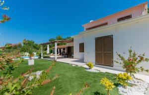 a white house with a yard with green grass at Villa Filomena - Omis by Villas Guide in Blato na Cetini