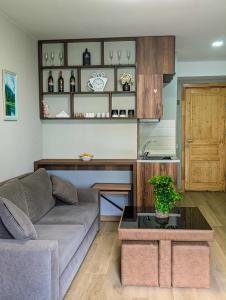 a living room with a couch and a table at Didveli Gallery B 109 in Bakuriani +3 photos