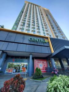 a tall building with a motorcycle parked in front of it at Studio Unit Pool View 3rd Floor at Centrio Tower beside Ayala Mall, CDO in Cagayan de Oro