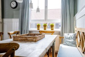 a table with a basket on it in a room with windows at Strömbergs Gunnar in Oberstaufen