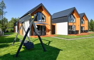a house with a playground in front of it at 2 Bedroom Awesome Home In Bialogora in Białogóra