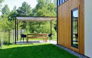 a patio with a table and chairs in a yard at 2 Bedroom Awesome Home In Bialogora in Białogóra