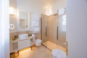 a white bathroom with a sink and a shower at Hotel Belvedere in Forte dei Marmi
