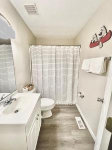 a bathroom with a toilet and a sink at Bungalow near the lake in Gainesville