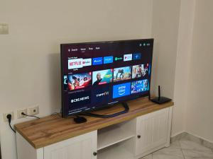 a flat screen tv sitting on top of a wooden stand at Flogita Dream in Flogita