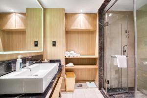 a bathroom with a sink and a shower at Atour Hotel Canal Hangzhou in Hangzhou +58 photos
