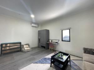 a living room with a bed and a table at U Residence in Bengkulu