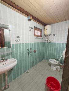 a bathroom with a sink and a toilet at Oran Stays Shoja in Shoja +23 photos