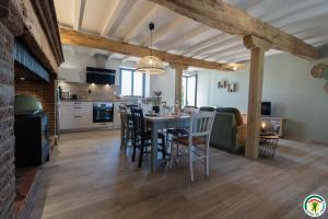 a kitchen and dining room with a table and chairs at Gîte la selve d'autan in Caraman