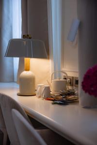 a table with a lamp on top of it at Hotel Belvedere in Forte dei Marmi