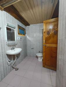 a bathroom with a sink and a toilet at Oran Stays Shoja in Shoja