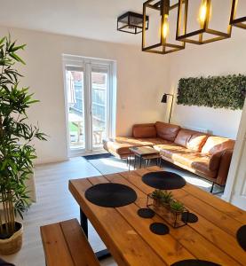 a living room with a couch and a table at Modern 2 Bed house - HS2, NEC & Birmingham Airport in Marston Green