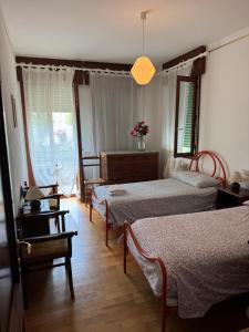 a bedroom with two beds and a table and chairs at Lido di Venezia Mare e Cinema in Venice-Lido