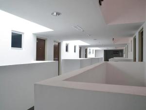 a white room with a white counter in a building at Aster+ Hotel Bukit Jalil in Kuala Lumpur