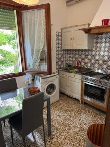 a kitchen with a table and a stove top oven at Lido di Venezia Mare e Cinema in Venice-Lido