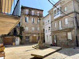 an empty street in an old city with buildings at Carmen Luxury House in Muros