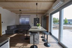 a kitchen and living room with a table and chairs at Klangor in Kopalino
