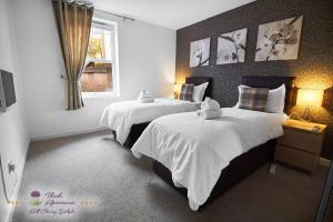 a hotel room with two beds and a window at Thistle Apartments - Marischal Square in Aberdeen