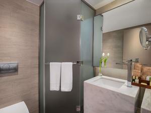 a bathroom with a shower and a sink at Rixos Premium Tekirova - The Land of Legends Access in Tekirova