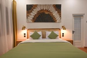 Postel nebo postele na pokoji v ubytování Huma Yogyakarta Hostel