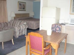 a living room with a table and a room with a couch at Atlantic Motel in Point Pleasant Beach
