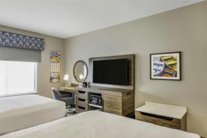 a hotel room with two beds and a flat screen tv at Hampton Inn & Suites By Hilton Decatur in Decatur