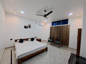 a bedroom with a bed and a ceiling fan at Uttam Hotel & Restaurant in Guwahati
