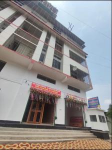 a white building with a lot of windows at Uttam Hotel & Restaurant in Guwahati