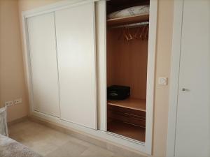 a closet with white cabinets in a room at El sol Espanol in Torrox Costa +16 photos