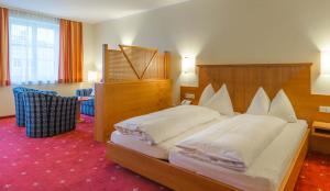 Postel nebo postele na pokoji v ubytování Posthotel Radstadt