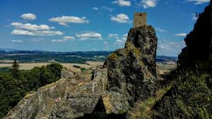 a stone tower on top of a mountain at Cabin berg in Semily
