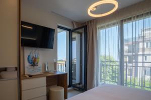 Ένα ή περισσότερα κρεβάτια σε δωμάτιο στο NEA Apartments