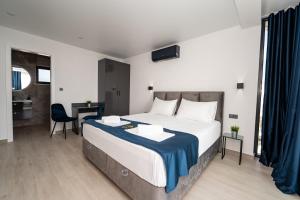 a bedroom with a large bed and a desk at Villa Dubai in Novalja +23 photos
