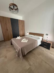 a bedroom with a bed with two towels on it at Casa Vacanze - Uliveto in Sciacca