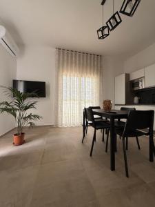 a dining room with a table and chairs in a room at Casa Vacanze - Uliveto in Sciacca