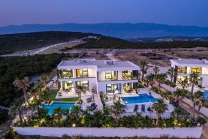an aerial view of a mansion with a swimming pool at Villa Dubai in Novalja