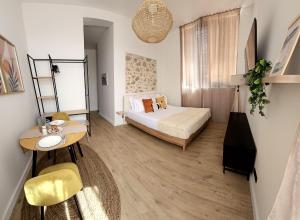 a bedroom with a bed and a desk and a table at Azura in Antibes