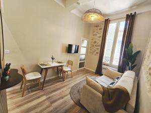 a living room with a couch and a table at Azura in Antibes